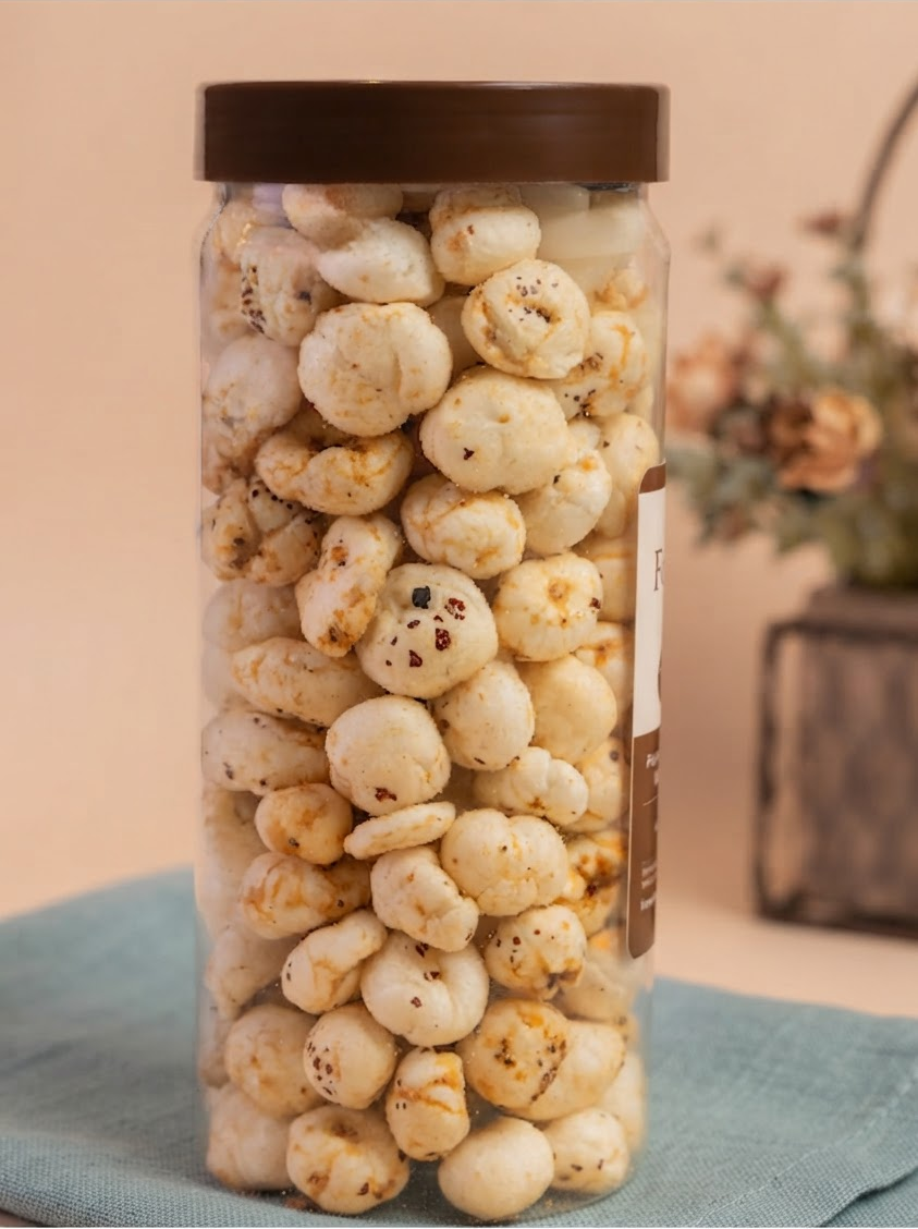 A tall jar of roasted makhana on a teal linen cloth