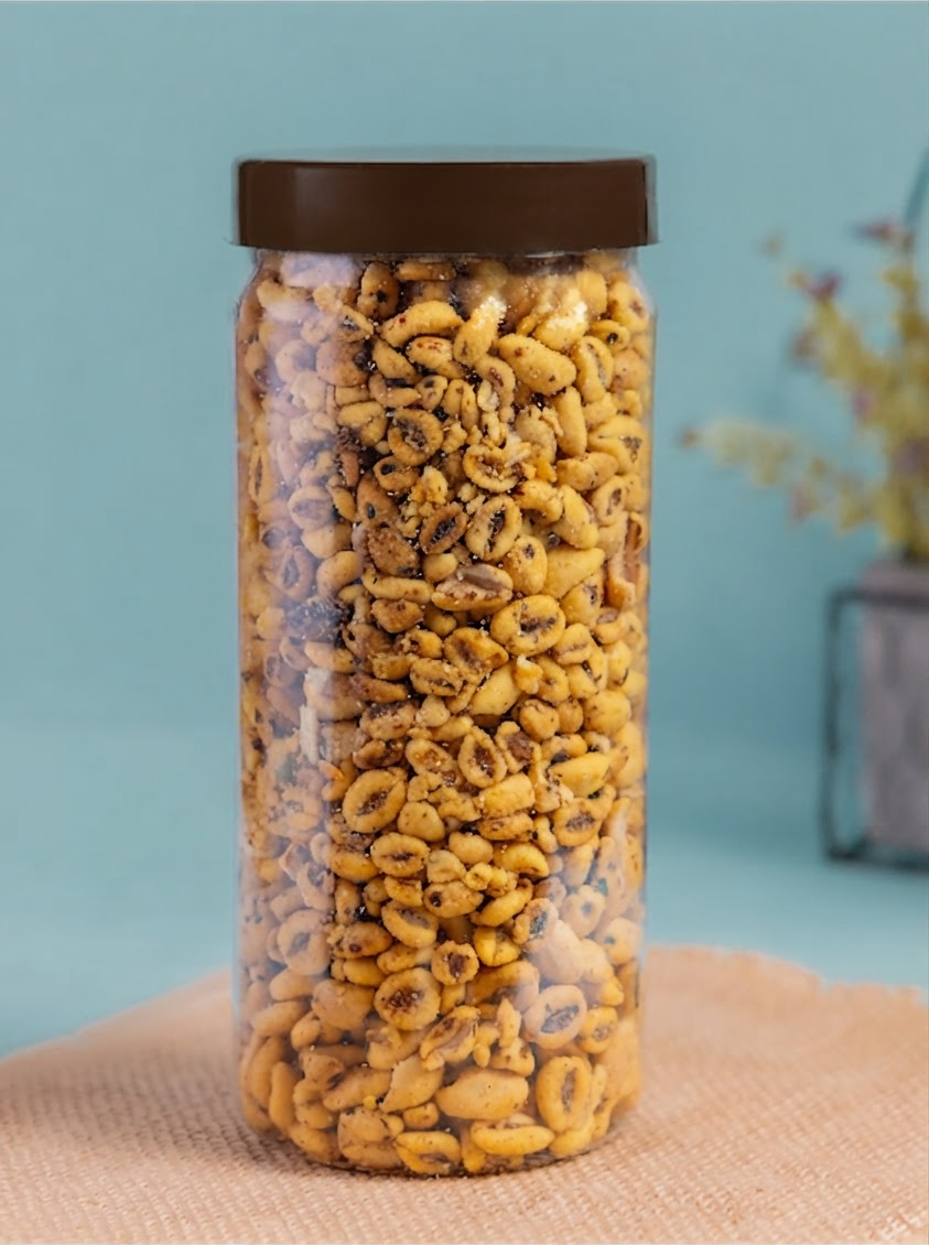 A jar of crunchy roasted wheat mixture against a soft teal wall