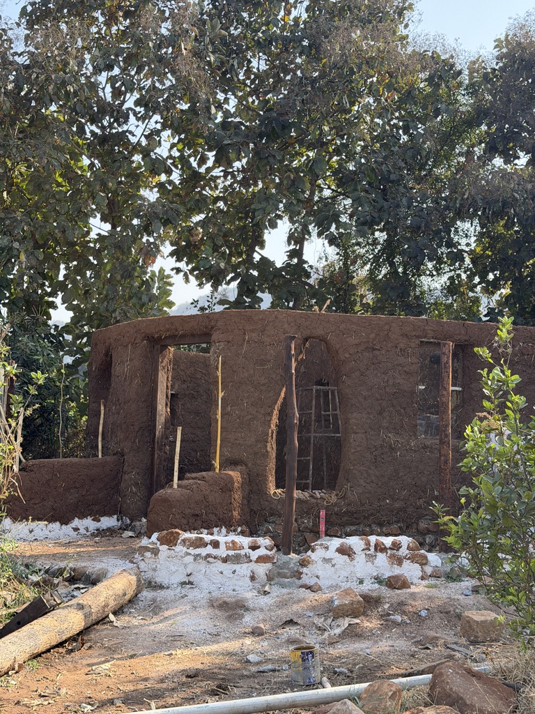 Thatched roof rising over a stone and mud base